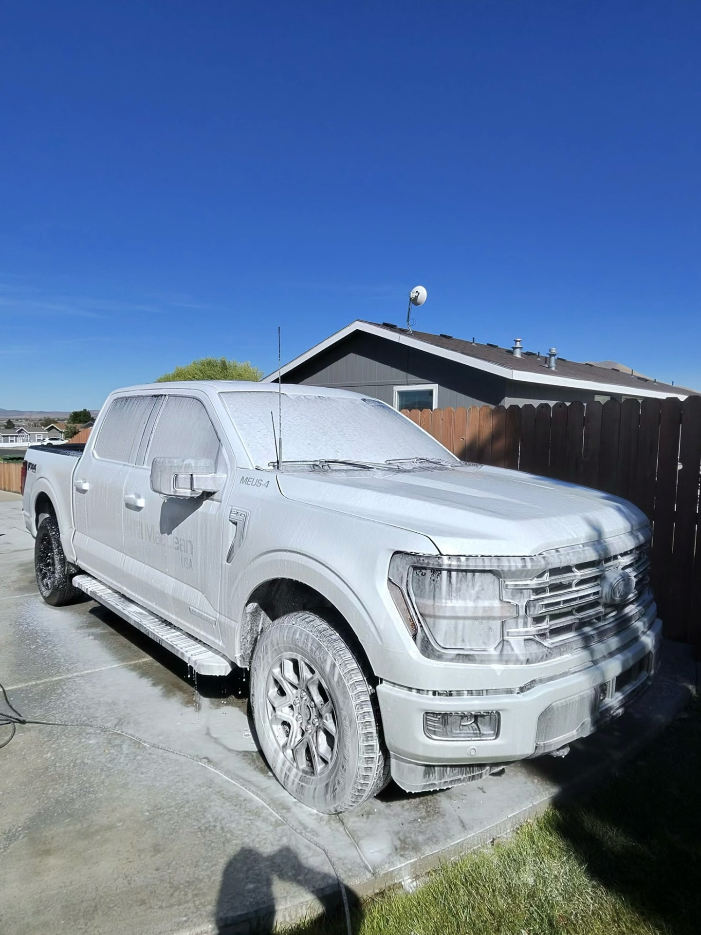 White Ford F-150 covered in wash foam